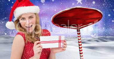 Female Santa holding gift and Wooden signpost in Christmas Winter landscape