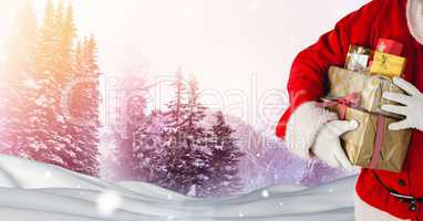 Santa holding gifts in Christmas Winter landscape