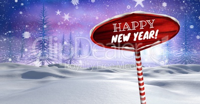 Happy New Year text on Wooden signpost in Christmas Winter landscape