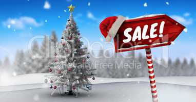 Sale text on Wooden signpost in Christmas Winter landscape and Santa hat with Christmas tree