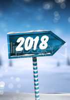 2018 New Year text on Wooden signpost in Christmas Winter landscape
