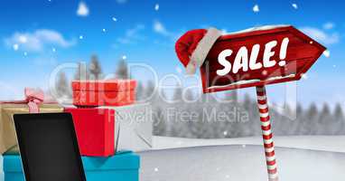 Sale text and gifts with Wooden signpost in Christmas Winter landscape and Santa hat