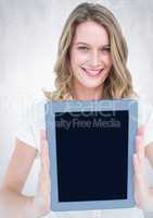 Woman holding tablet with bright background