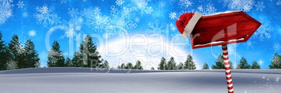 Wooden signpost in Christmas Winter landscape and Santa hat