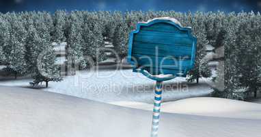 Wooden signpost in Christmas Winter landscape