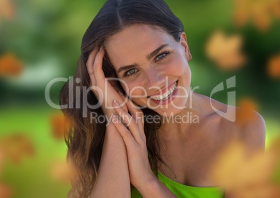 Woman's face in green nature with leaves