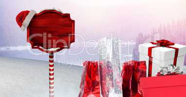 Gifts and Wooden signpost in Christmas Winter landscape and Santa hat