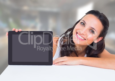 Woman holding tablet with office background