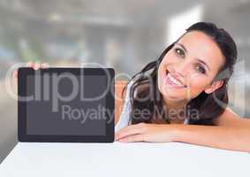 Woman holding tablet with office background