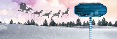 Wooden signpost in Christmas Winter landscape and Santa's sleigh and reindeer's