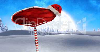 Wooden signpost in Christmas Winter landscape and Santa hat