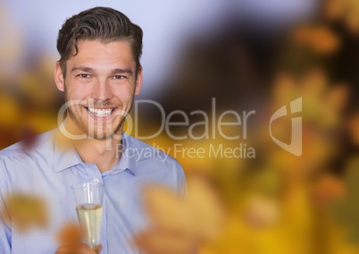 Man with champagne in forest with leaves