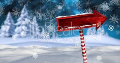 Wooden signpost in Christmas Winter landscape