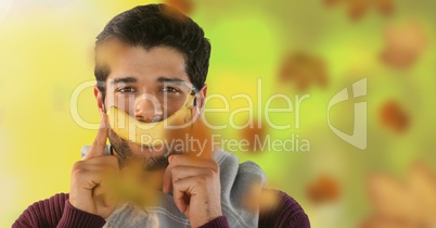 Man's face in forest with leaves and banana smile