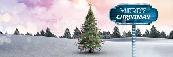 Merry Christmas text on Wooden signpost in Christmas Winter landscape with Christmas tree