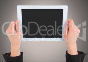 Hand holding tablet with grey background