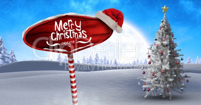 Merry Christmas text on Wooden signpost in Christmas Winter landscape and Santa hat with Christmas t