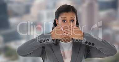 Businesswoman with hands over mouth in city