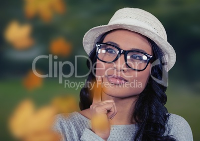 Woman's face in nature with leaves and glasses