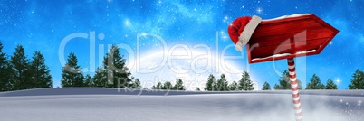 Wooden signpost in Christmas Winter landscape and Santa hat