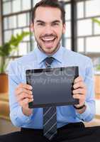 Man holding tablet with windows background