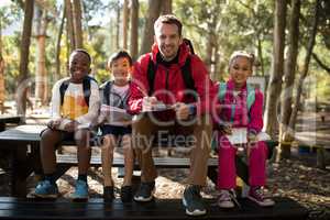 Portrait of teacher assisting kids in studying