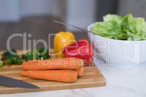 Vegetables kept on chopping board in kitchen