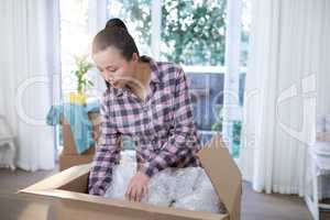 Woman unpacking boxes in new home