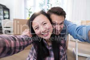 Couple having fun at their new house