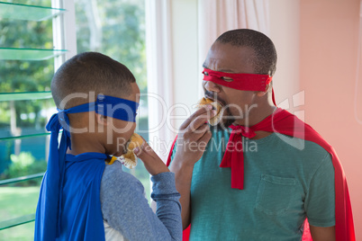 Father and son having muffin