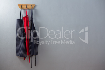 Various aprons hanging on hook