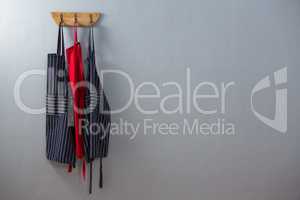 Various aprons hanging on hook