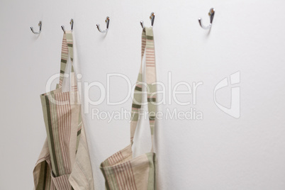 Aprons hanging on hook