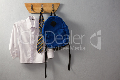 School uniform and schoolbag hanging on hook
