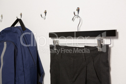 School uniform and schoolbag hanging on hook