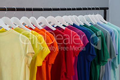 Various t-shirts hanging on cloth hanger