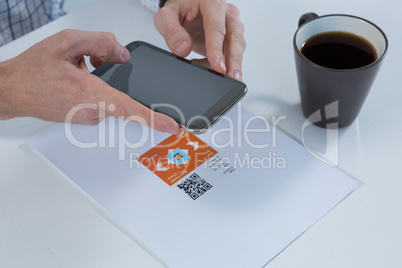 Male executive using mobile phone at desk