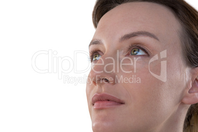 Woman looking away against white background