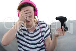 Upset woman in headphones holding joystick