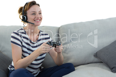 Woman in headphones playing video game