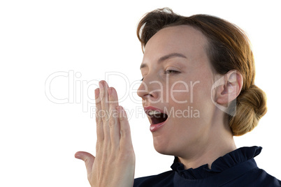 Female executive yawning against white background