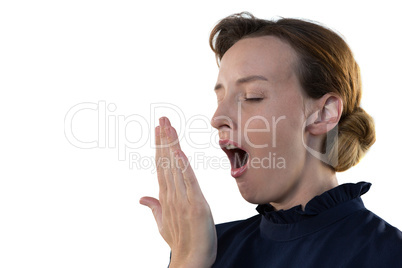 Female executive yawning against white background