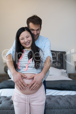 Happy man and woman feeling the presence of baby