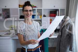 Fashion designer holding a document