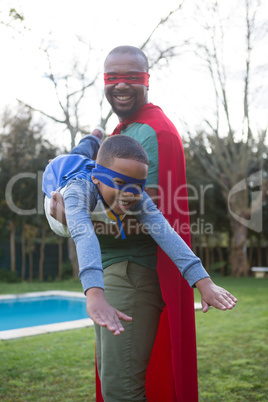 Son and father pretending to be a superhero