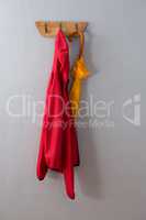 Red hoodie and umbrella hanging on hook