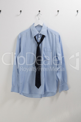 Shirt with tie hanging on hook