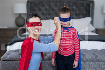 Mother and daughter pretending to be superhero