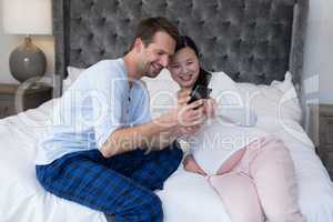 Happy couple reviewing picture on mobile phone
