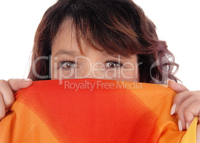 Woman holding scarf over mouths